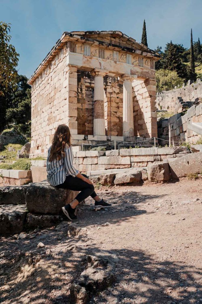 Me sitting in front of the restored Athenian Treasury, Delphi - La Vie En Marine