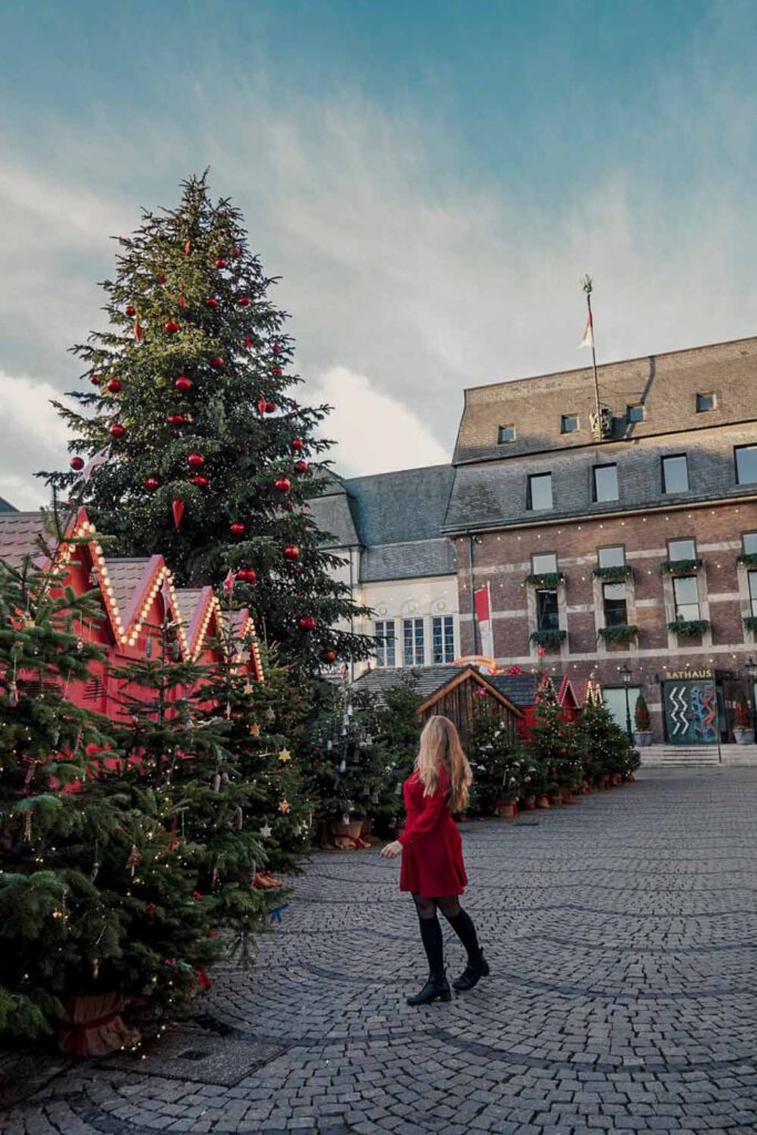 Girl in front of giant christmas tree