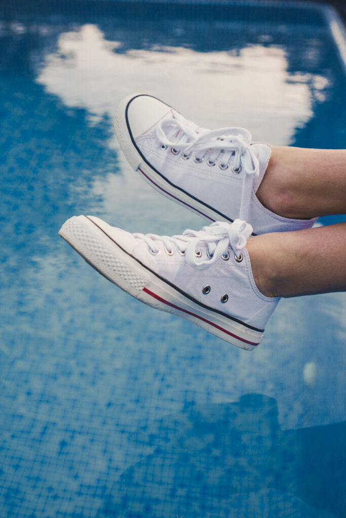 white sneaker by ethletic above a pool