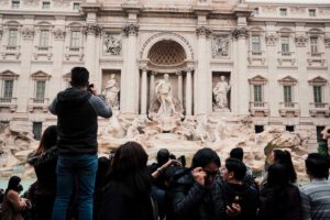 crowds standing in front of Trevi Fountain