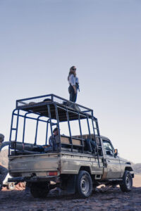 Girl standing on Top of a Jeep in Wadi Rum