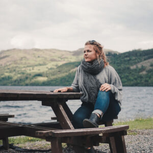 Girl Sitting in Front of Loch Ness