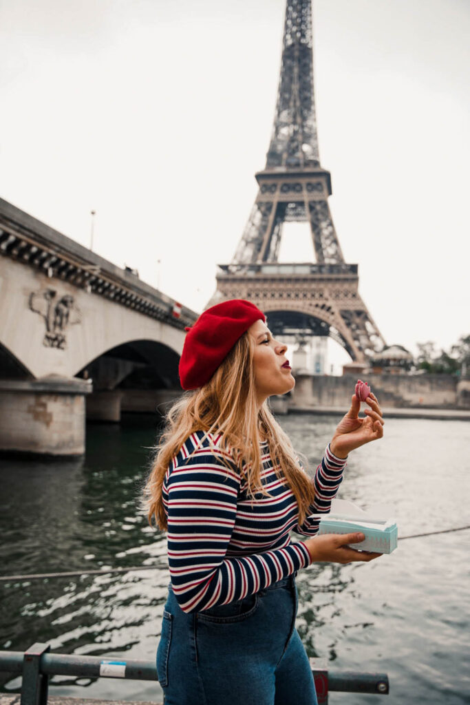 I am standing next to the Seine in Paris, just in front of the Eiffel Tower. In a striped shirt and wearing a red beret, I am eating Macarons by Maison Ladurée. In my opinion, macarons by Ladurée are the best you can find in Paris!