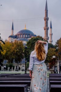 Girl standing in front of the blue mosque, one of the highlights of Istanbul