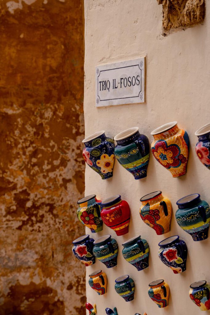 Gozo is such a beautiful island with many cute details like these colorful amphoras hanging from a wall, making it one of the best places in Malta. 