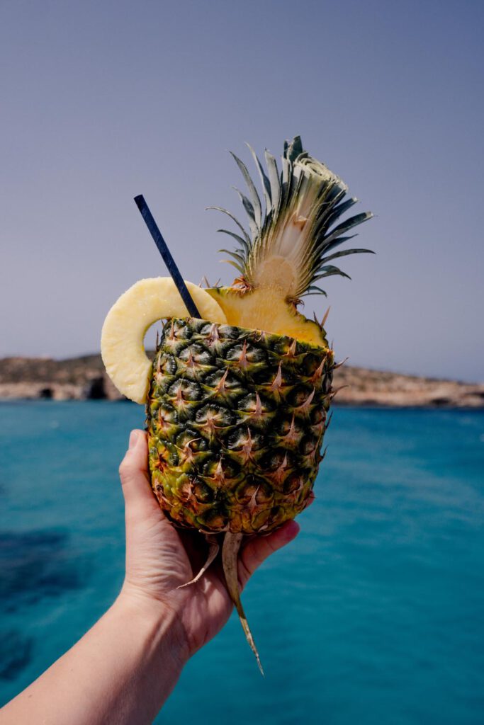 Is there a better feeling than sipping on a pineapple cocktail while chilling in the Blue Lagoon, one of the best places in Malta? 