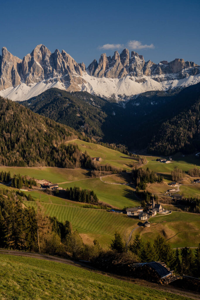 At the feet of the mountain range, a village is nestled in the Val di Funes with the most breathtaking church. 